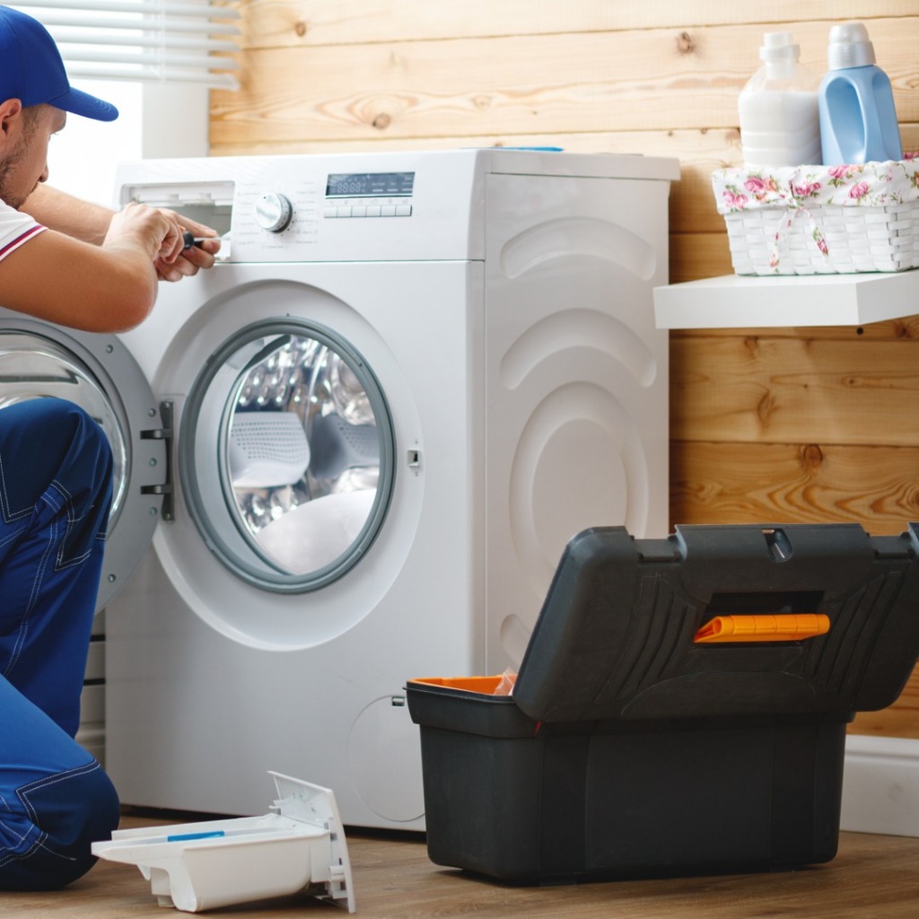 Technician repairing washer control panel